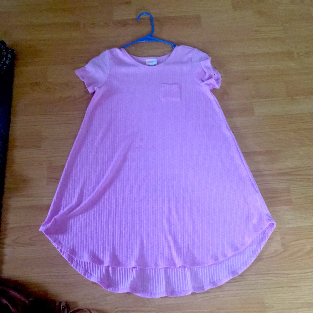 A light purple, loose fitting dress.